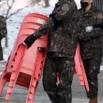 Jin serving in the military.