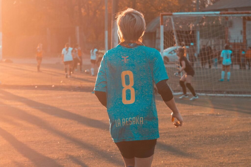 Customized football jersey design template with options for colors, logos, and names.