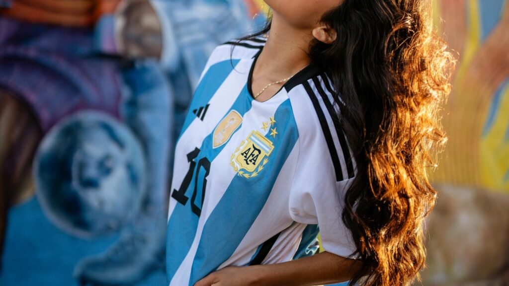 woman wearing a football jersey with pride on game day